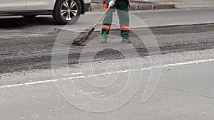 Bad road. Roller and workers on asphalting and repair of city streets.