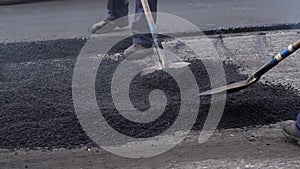 Bad road. Roller and workers on asphalting and repair of city streets.