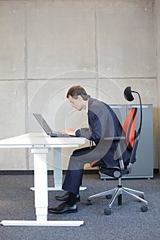 Bad sitting posture at laptop