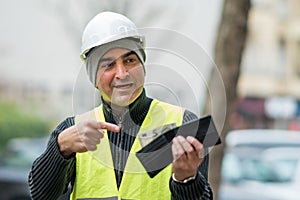 Bad times: poor construction worker and his empty wallet