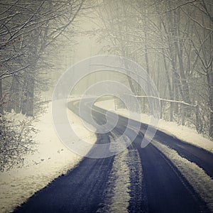 Bad weather driving - foggy hazy country road. Motorway - road traffic. Winter time and snow