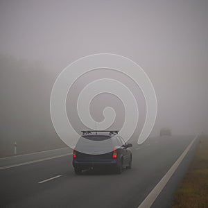 Bad weather driving - foggy hazy country road. Motorway - road traffic. Winter time