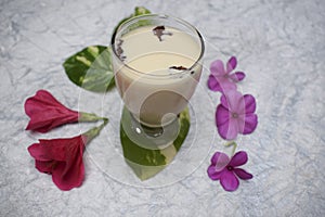 Badam milkshake Indian bevarage flavored with almond, cardamom, rose petals.Rich health populare traditional Indian, Pakistani,