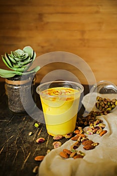 Badam sharbat, Almond milk syrup with saffron served in glass isolated on table top view of drink