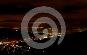 Baden-Baden night. Sparkling aerial view of downtown . Illuminated buildings and deep blue sky.