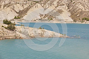 Badlands landscape and blue waters in Algeciras reservoir. Spain