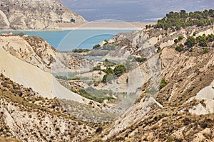 Badlands landscape and blue waters in Algeciras reservoir. Spain