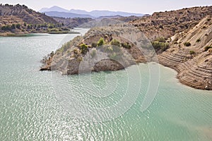 Badlands landscape and blue waters in Algeciras reservoir. Spain