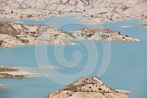 Badlands landscape and blue waters in Algeciras reservoir. Spain