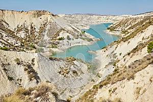 Badlands landscape and blue waters in Algeciras reservoir. Spain