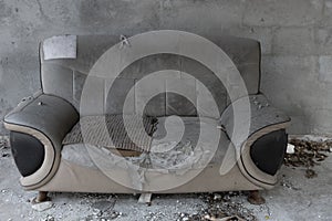 A badly damaged sofa at horizontal composition