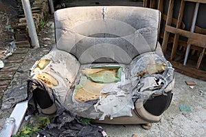 Badly damaged sofa in the outdoor at horizontal composition