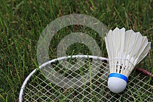 Badminton Birdie Shuttlecock Racket On Green Grass photo