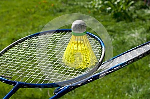 Badminton equipment on green grass background