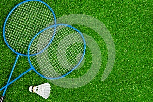 Badminton game rackets and shuttlecock on grass