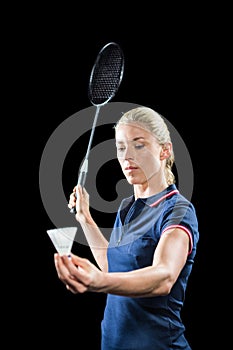 Badminton player holding a racquet ready to serve