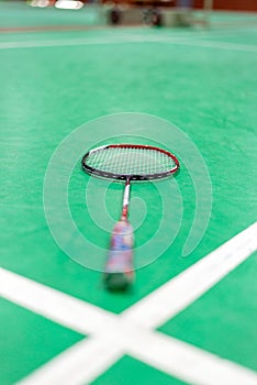 badminton racket on green court