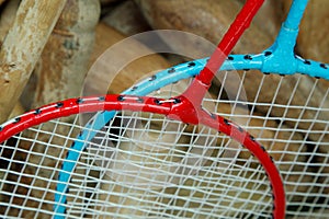 Badminton rackets in a box with wooden croquet mallets