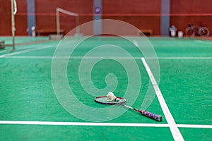 badminton shuttlecock and racket on green court