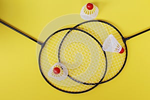 Badminton. Three shuttlecocks and two badminton rackets