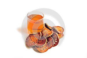 Bael fruit tea and slices of dried bael fruit, tea matum on white