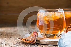 Bael juice ice tea on wooden table , healthy drink