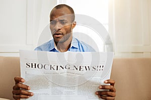Baffled man reading shocking news