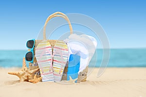 Bag and beach objects near sea, space for text