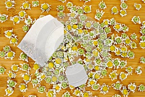 Bag of chamomile tea with dry chamomilla flowers photo
