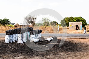 Bag of charcoal along the road in africa photo