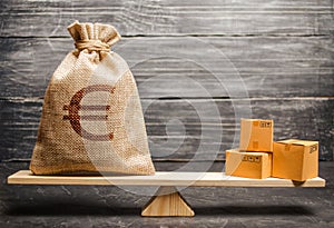 A bag of euro money and a bunch of boxes on the scales. Economic relations between subjects, the global economic model. Conceptual