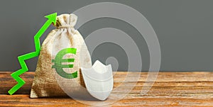 Bag with the Euro sign, green up arrow and metal shield. Euro zone. concept of growth and protection of investments, guarantee