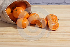 Bag of Fresh Oranges on Wooden Table