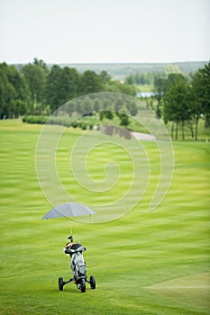 Bag with golf clubs and umbrella