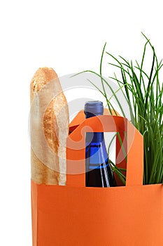Bag with greens, baguette, and wine bottle
