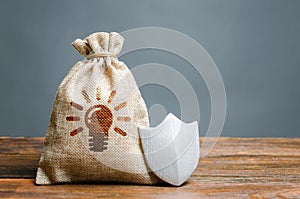 A bag with ideas or patents and a shield. The concept of protection of copyright and patents for inventions. Non-disclosure photo