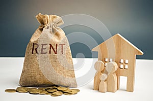 A bag with money and the inscription Rent and the family is standing near the house. Removable housing. Rental of property,