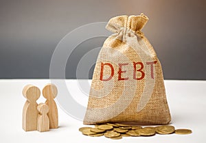 A bag of money with the word Debt and the family standing near the house. The concept of debt for housing. Mortgage. Real estate,