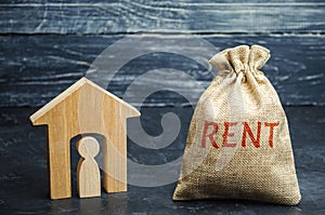 A bag with money and the word Rent and a house with a tenant inside. The accumulation of money to pay rental housing. Rental