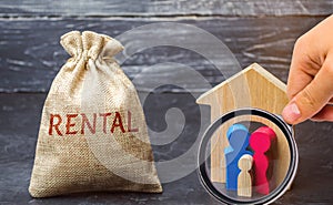 A bag with money and the word Rental and a family standing near the house. The accumulation of money to pay rental housing. Rental