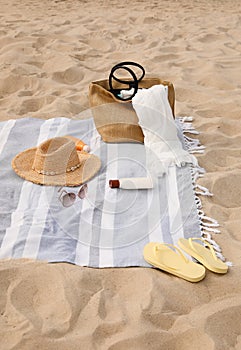 Bag and other beach items on sand