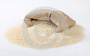 Bag and pile of white long grained rice photo