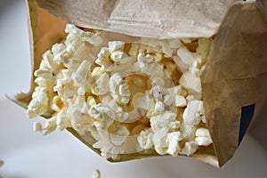 A bag of popcorn open on a plate in the kitchen