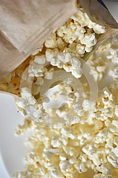 A bag of popcorn open on a plate in the kitchen