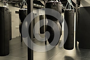 bag punching boxing background indoors, from power kick from punch for hobbie strength, knockout target. Leather energy