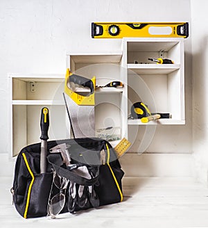 Bag with a set of tools. The installation of furniture drawers photo