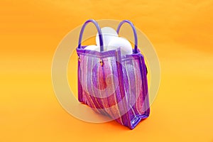 Bag to go to the market, sent or super Mexican style, with white eggs inside, on an orange background