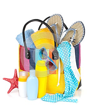 Bag with towels, sunglasses, flip-flops and beach items