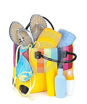 Bag with towels, sunglasses, flip-flops and beach items