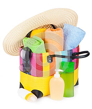 Bag with towels, sunglasses, hat and beach items